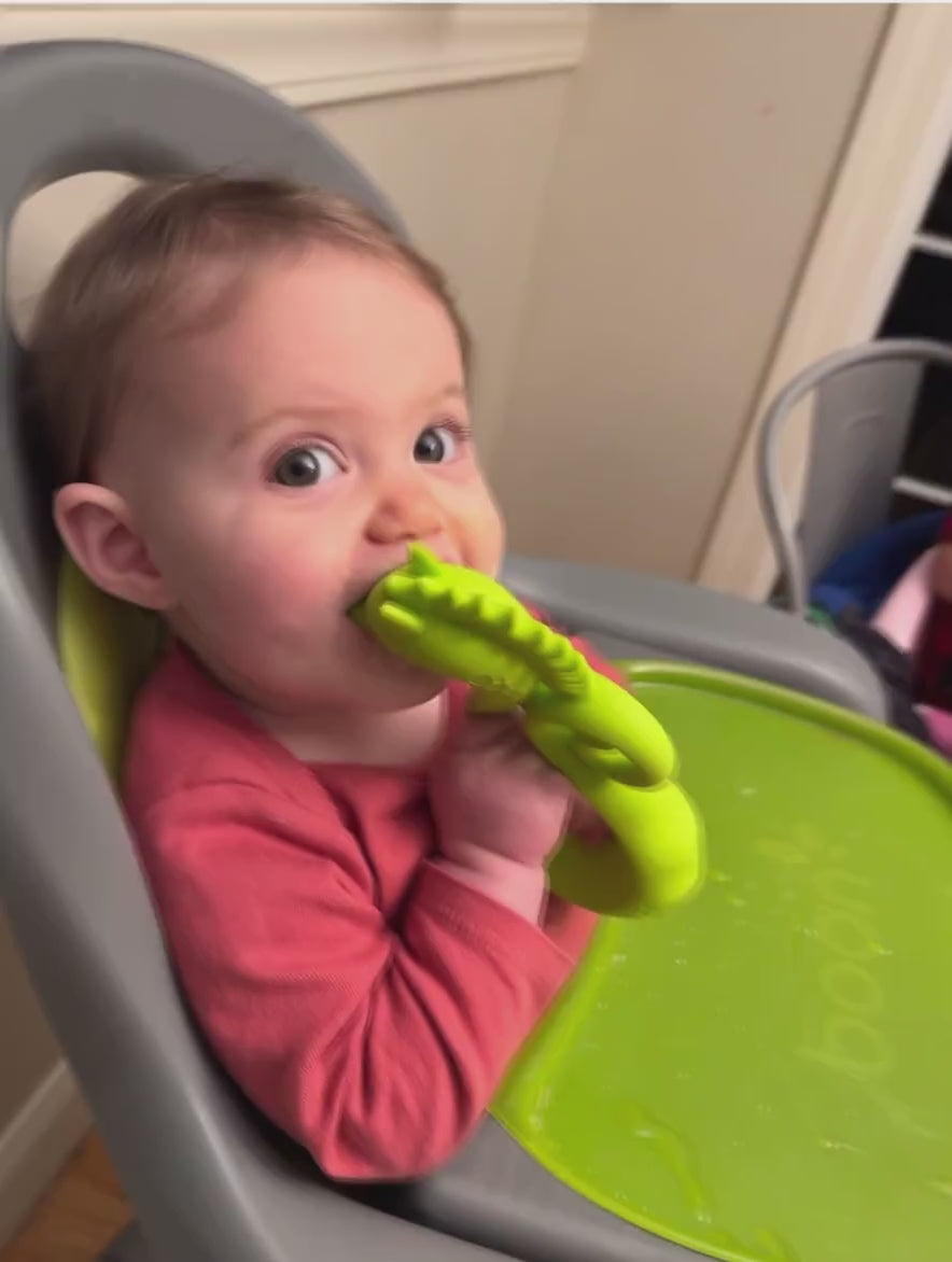 Baby playing with Choo Choo the Seahorse teether 